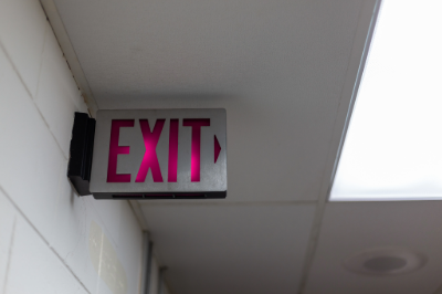 Avoid rushing toward stairways or exits immediately, as large crowds can create dangerous bottlenecks. 